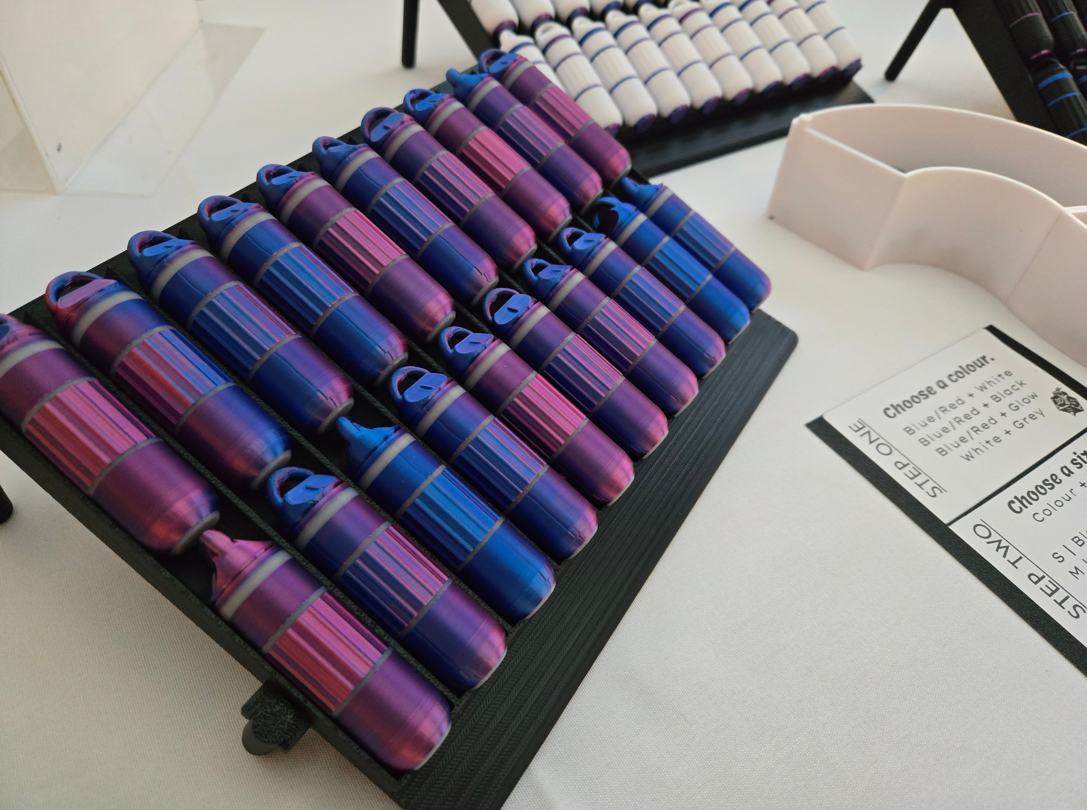 Set of colorful cases on a stand with a more in the background